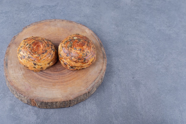 Traditional Azerbaijani cookie sweet gogals on a board on marble table.