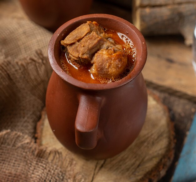 Traditional Azerbaijani meal piti in pottery cup with meat.