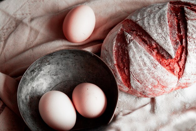 Traditional bread, egg bowl on a white rustic towel.