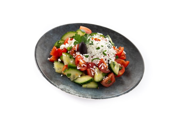 Traditional Bulgarian shopska salad with tomatocucumber and bulgarian sirene cheese isolated on white background