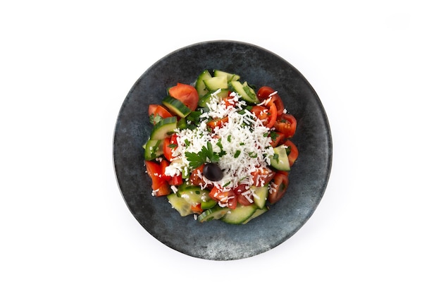 Traditional Bulgarian shopska salad with tomatocucumber and bulgarian sirene cheese isolated on white background