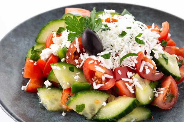 Traditional Bulgarian shopska salad with tomatocucumber and bulgarian sirene cheese isolated