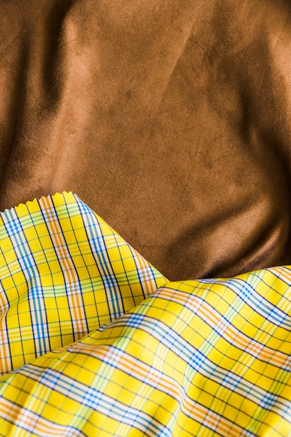 Traditional checkered fabric texture on brown drape textile