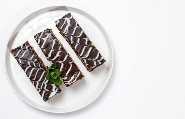 Traditional chocolate millefoglie or french mille-feuille on white background with copy space