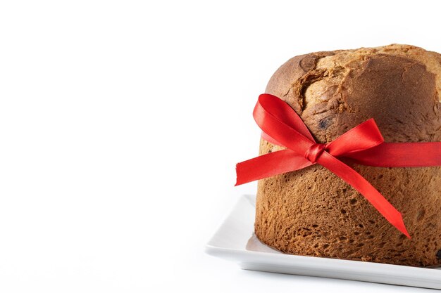 Traditional Christmas panettone with red tie isolated on white background