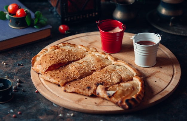 Traditional crepe kutab sliced and served with sauces.