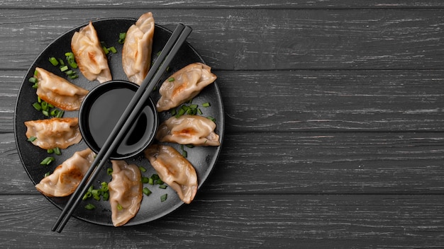 Traditional dumplings on plate with chopsticks