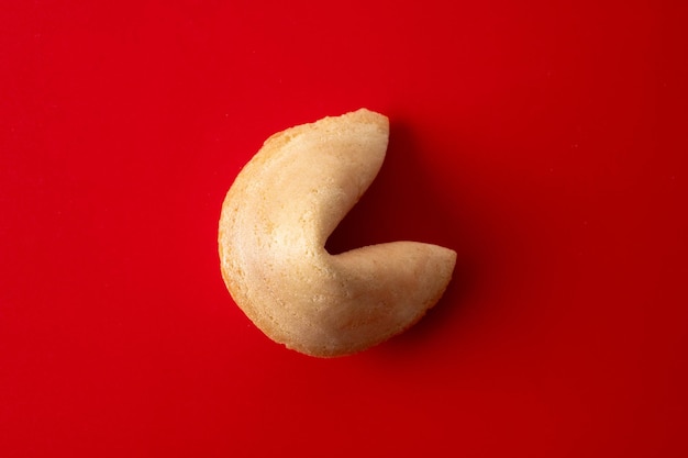 Free photo traditional fortune cookie on red background