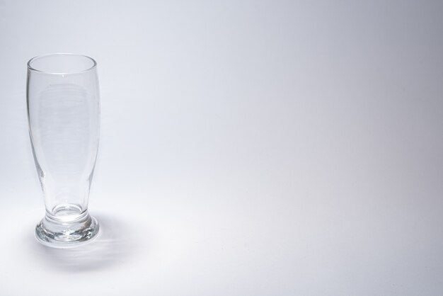 Traditional glass cup over white table with copyspace