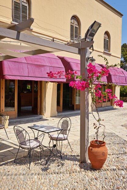 Traditional greek street cafe with flowers