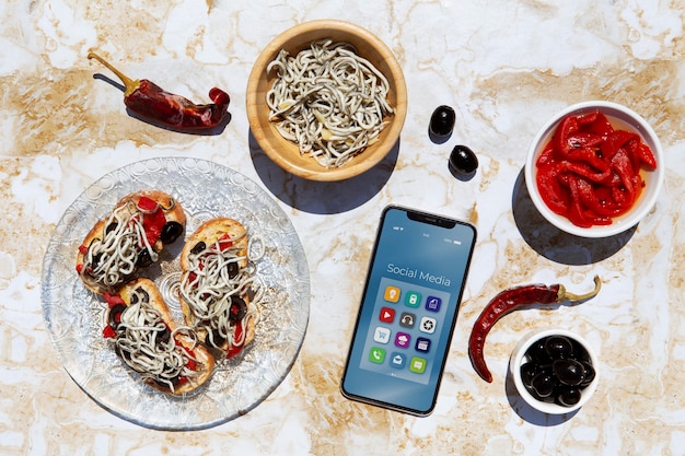 Traditional gulas dish arrangement with smartphone