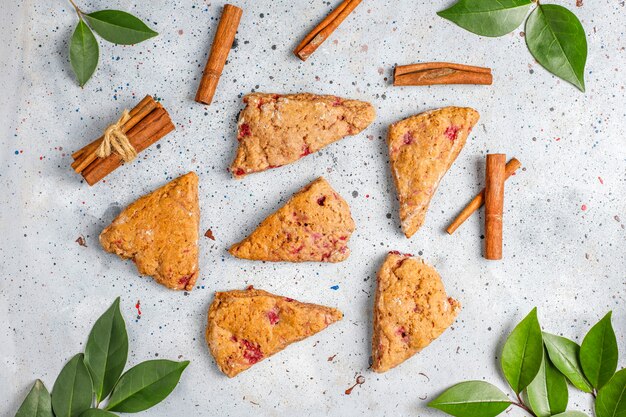 Traditional homemade English scones with frozen raspberries and cinnamon,top view