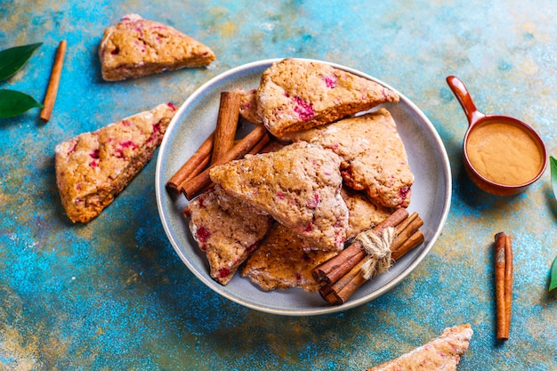 Traditional homemade English scones with frozen raspberries and cinnamon,top view