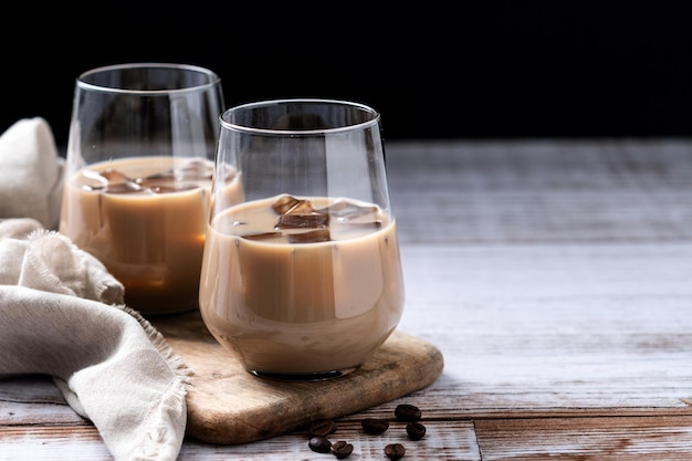 Traditional irish cream coffee liqueur with ice on wooden table