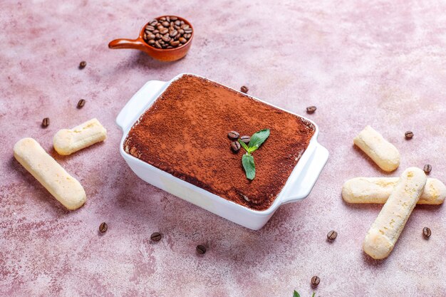 Traditional italian dessert tiramisu in ceramic plate,top view.