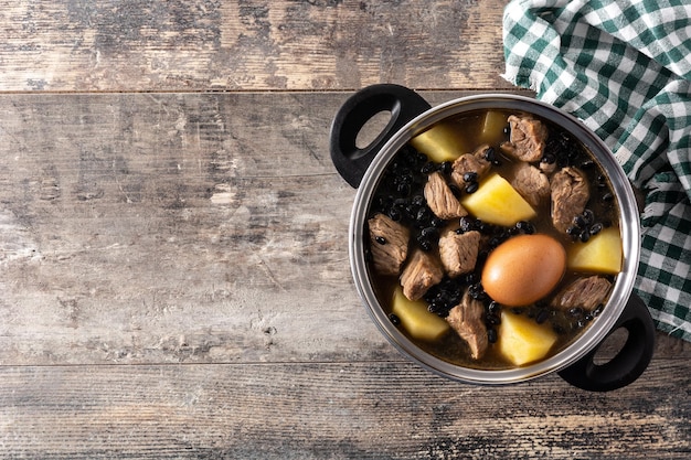 Traditional Jewish cholent on wooden table