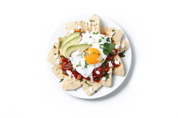 Free photo traditional mexican breakfast red chilaquiles with egg isolated on white background