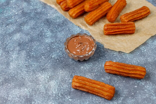 Traditional Mexican dessert churros with chocolate,top view