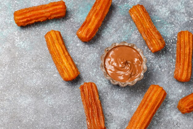 Traditional Mexican dessert churros with chocolate,top view