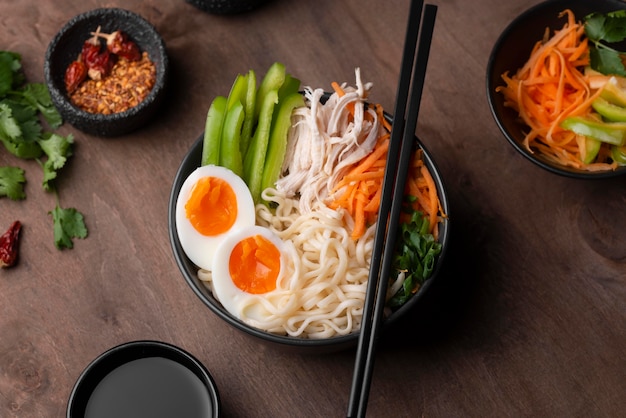 Traditional noodles in bowl with eggs and vegetables