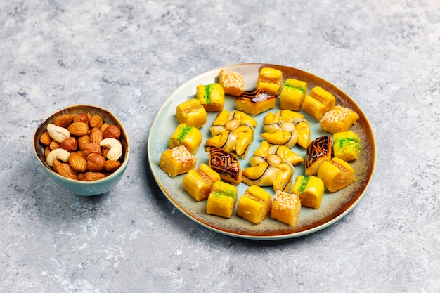 Traditional oriental sweets with different nuts on concrete surface