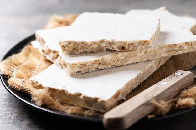 Free photo traditional pieces of delicious christmas almond nougat on wooden table