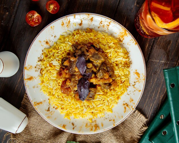 Traditional pilaf with meat and boiled fruits