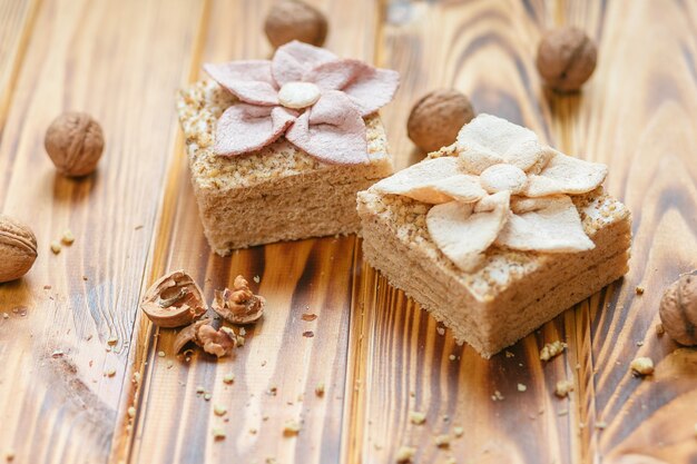 Traditional Russian dessert - pastila and hazelnuts on rustic wooden background.