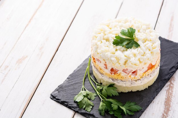 Traditional Russian layered salad Mimosa