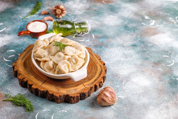 Traditional russian pelmeni or dumplings with meat. Free Photo