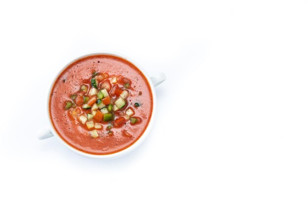 Traditional Spanish gazpacho soup in bowl isolated on white background