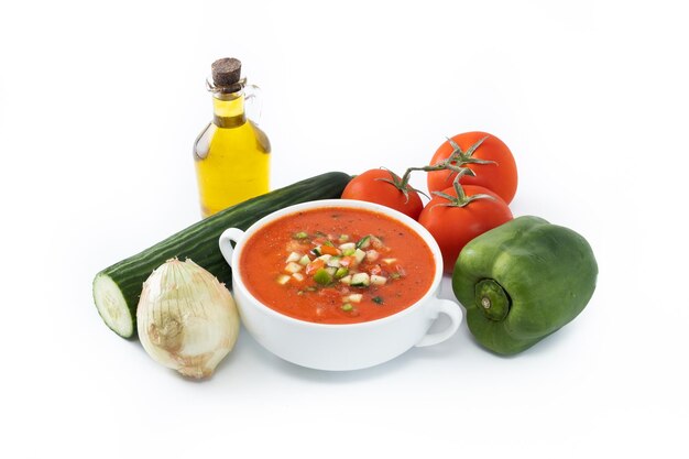 Traditional Spanish gazpacho soup in bowl isolated on white background
