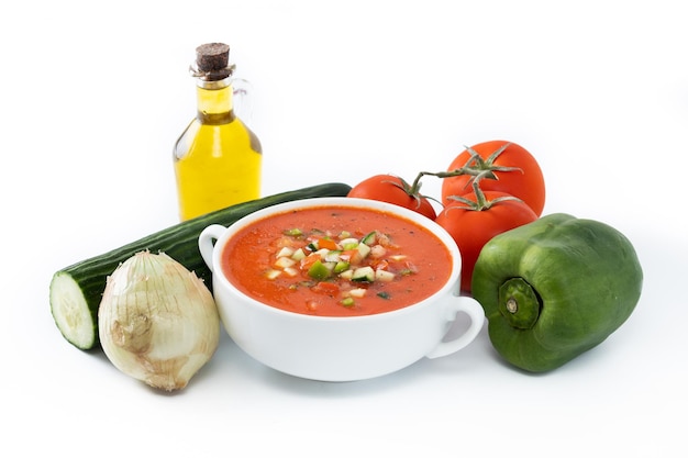 Traditional Spanish gazpacho soup in bowl isolated on white background