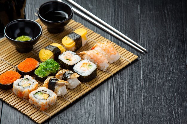 Traditional sushi on dark surface