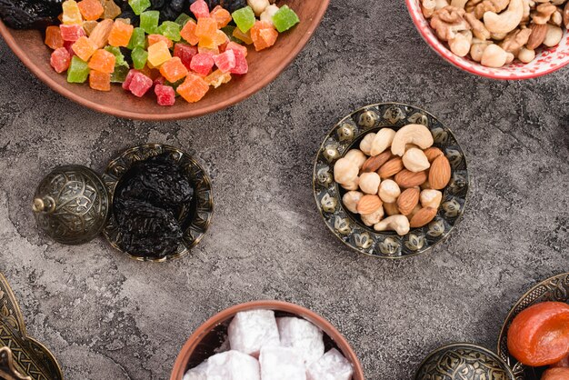 Traditional turkish arabic dried fruits and nuts on gray concrete backdrop
