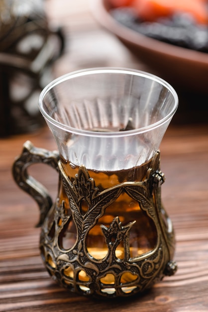 Free photo traditional turkish arabic tea glass one wooden desk