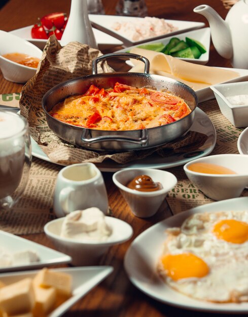 traditional turkish breakfast with sunny side up eggs, nutella, egg dish menemen
