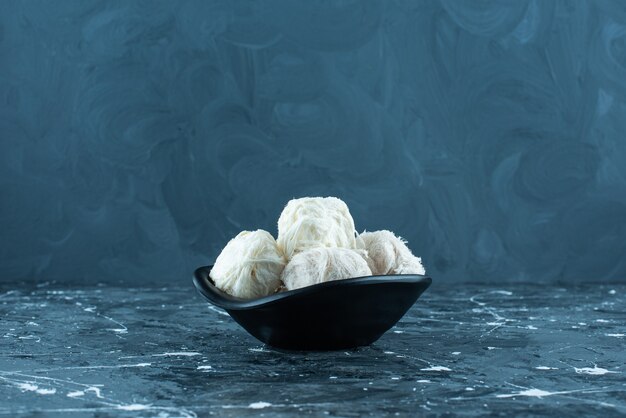 Traditional Turkish cotton candy in a bowl on blue. 