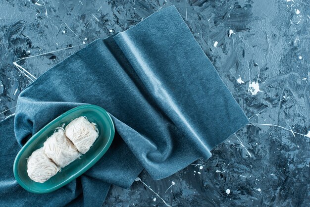 Traditional Turkish cotton candy on a plate on a towel , on the blue table. 