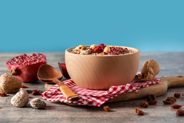 Free photo traditional turkish noah's pudding in bowl on wooden table