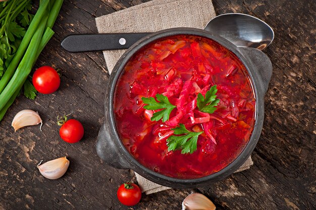 Traditional Ukrainian Russian vegetable borsch on the old wooden surface