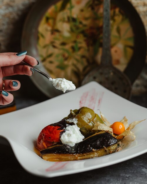 Traditional vegetable olma in a white plate with yogurt 