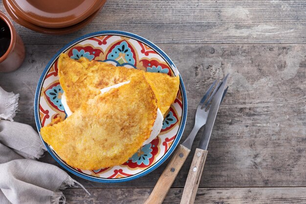 Traditional Venezuelan beef cachapa on wooden table