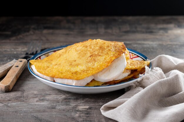 Traditional Venezuelan beef cachapa on wooden table