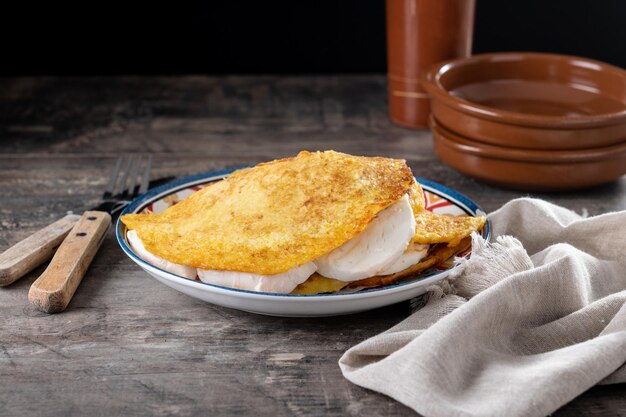 Traditional Venezuelan beef cachapa on wooden table