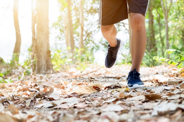 Trail running man exercising outdoors for fitness.