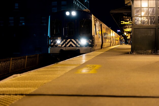 Train passing by station at night