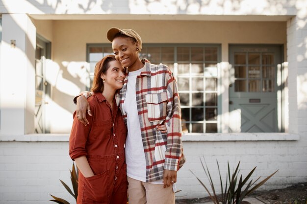 Trans couple holding each other and being affectionate on the city streets