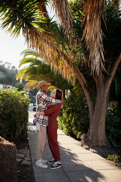 Trans couple hugging and being affectionate on the city streets