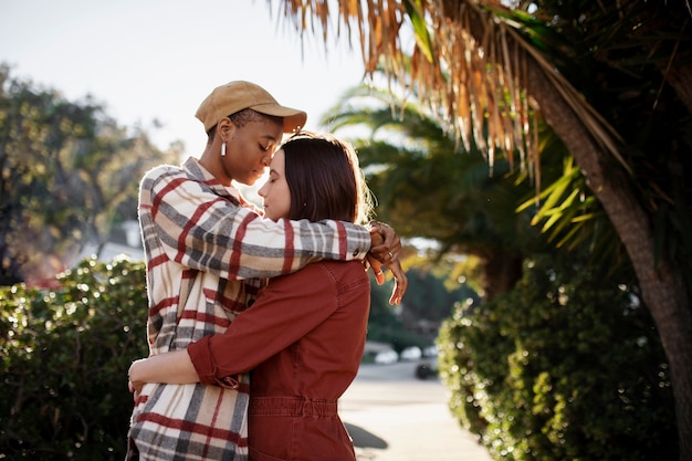 Trans couple hugging each other while keeping their eyes closed